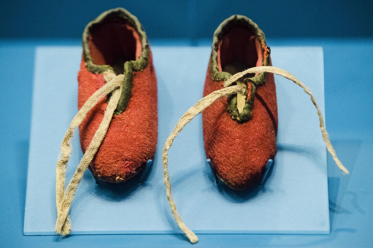 This Tuesday, April 4, 2017, photo shows a newborn’s shoes made from a British red coat brought back at the end of the Revolutionary War and preserved through generations of descendants of a Massachusetts soldier, at the Museum of the American Revolution